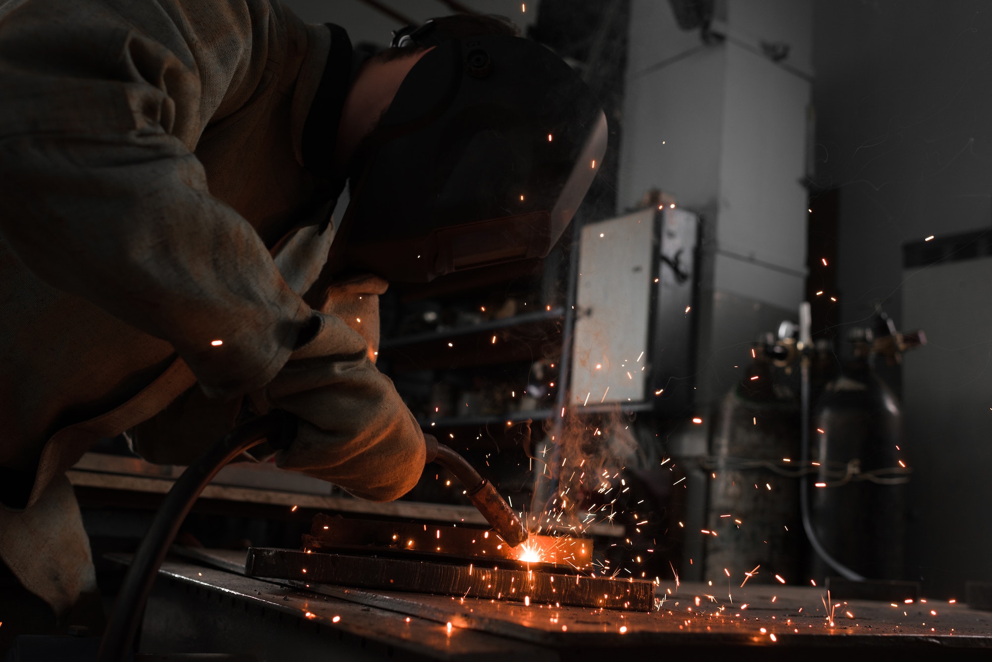 Manufacture Worker Welding Metal With Sparks at Factory